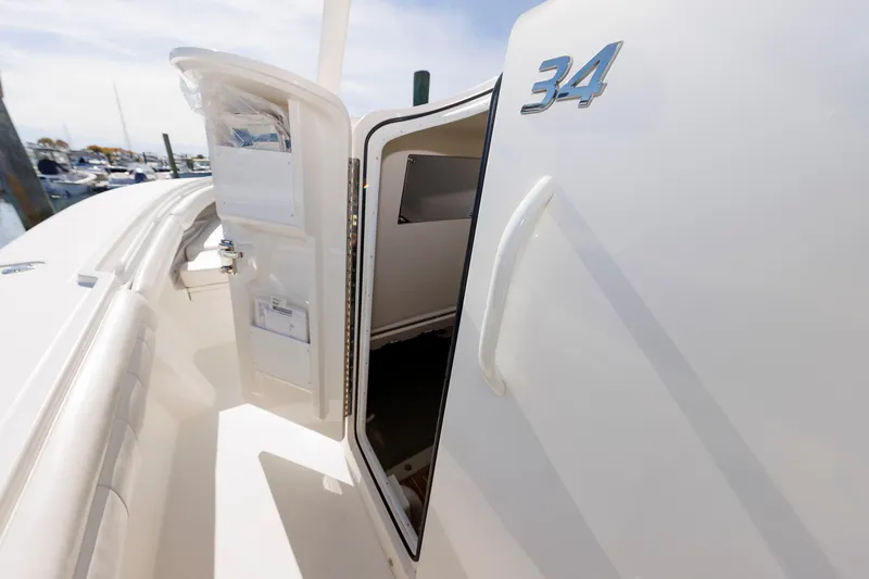 Slide: The Image of The 2018 Regulator 34SS features an open cabin door and a storage compartment. - 38