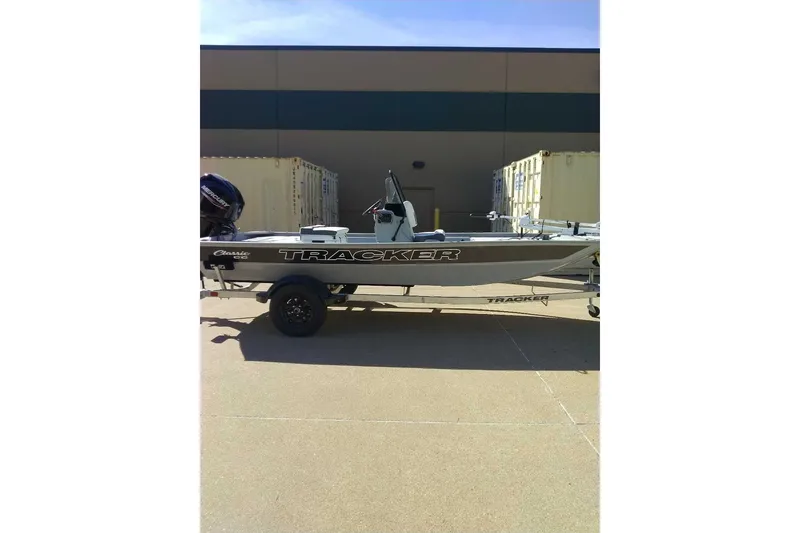 The Image of 2027 Tracker Bass Tracker Classic CC boat on trailer, parked outdoors. - 0