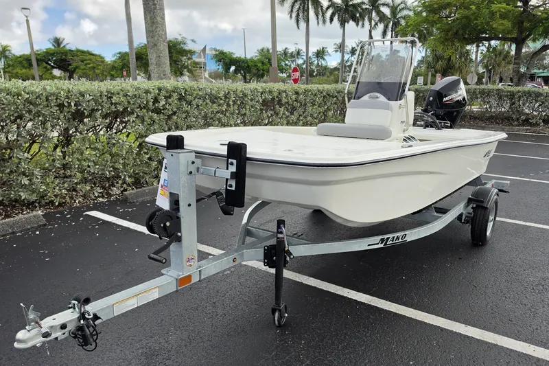 Slide: The Image of 2026 Mako Pro Skiff 13 CC boat on trailer in parking lot. - 4
