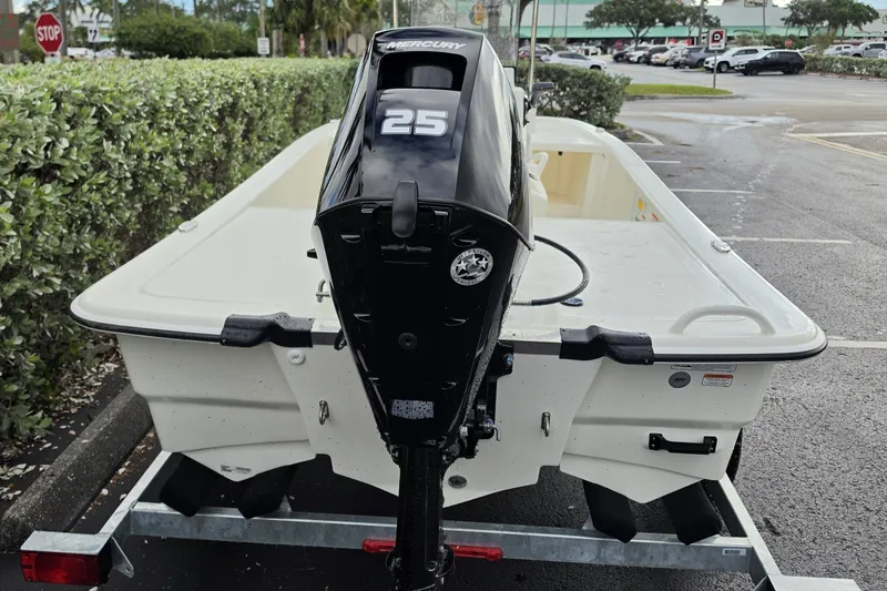 Slide: The Image of 2026 Mako Pro Skiff 13 CC with Mercury 25 engine on trailer in parking lot. - 11