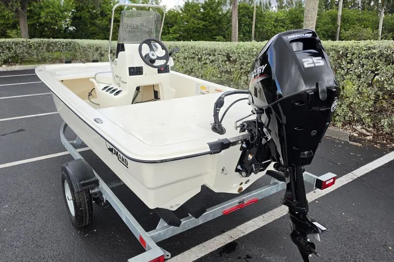 Slide: The Image of 2026 Mako Pro Skiff 13 CC boat with Mercury 25 engine on trailer. - 9