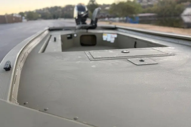 Slide: The Image of 2027 Tracker Grizzly 1654 T Sportsman boat, showcasing deck and storage compartments. - 16