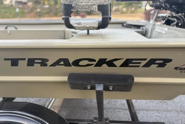 Slide: The Image of 2027 Tracker Grizzly 1654 T Sportsman boat on trailer, close-up view. - 17