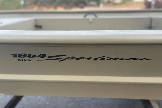 Slide: The Image of 2027 Tracker Grizzly 1654 T Sportsman boat, featuring "1654 MVX Sportsman" branding. - 18