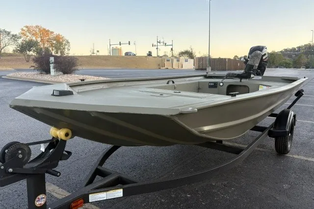 Slide: The Image of 2027 Tracker Grizzly 1654 T Sportsman boat on trailer in parking lot. - 14