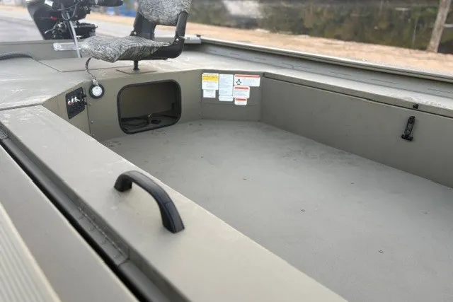 Slide: The Image of 2027 Tracker Grizzly 1654 T Sportsman boat interior with seating and storage compartments. - 20
