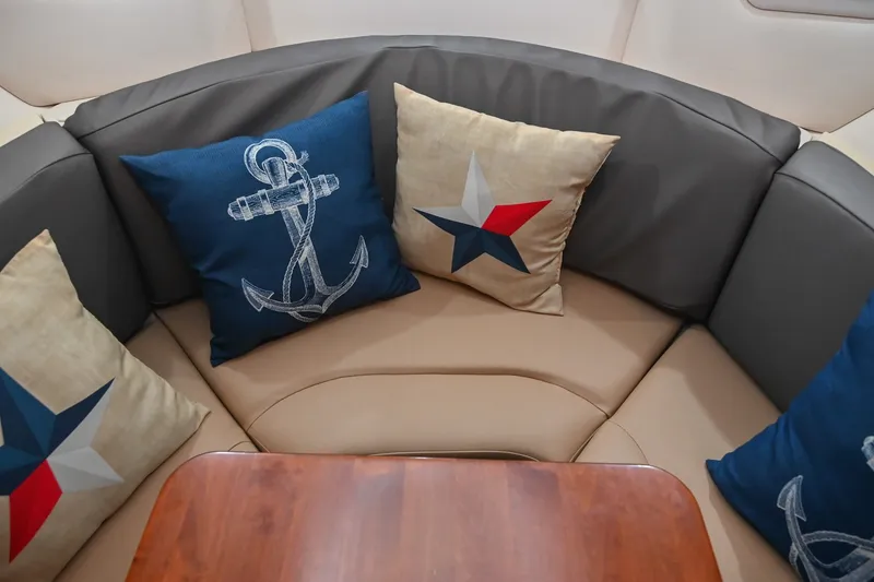 Slide: The Image of Cozy seating area on 2014 Sea Ray Sundancer 260 with nautical-themed cushions. - 50