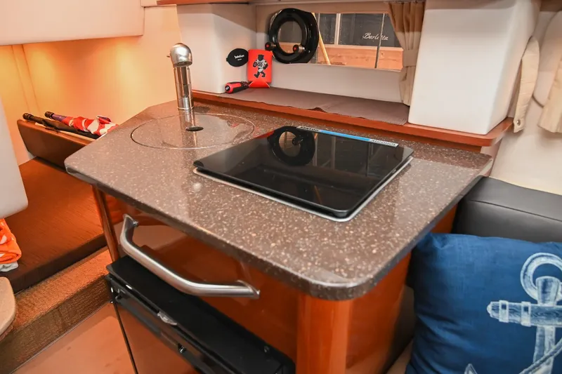 Slide: The Image of Interior of 2014 Sea Ray Sundancer 260 with kitchenette and modern amenities. - 42