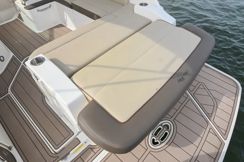 Slide: The Image of 2014 Sea Ray Sundancer 260 boat with cushioned seating and teak-style deck. - 23