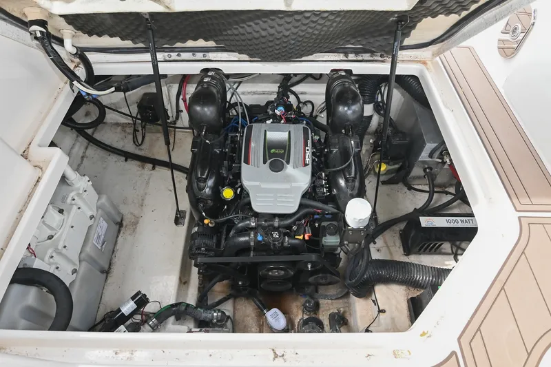 Slide: The Image of Engine compartment of a 2014 Sea Ray Sundancer 260 boat, showcasing the engine and components. - 58