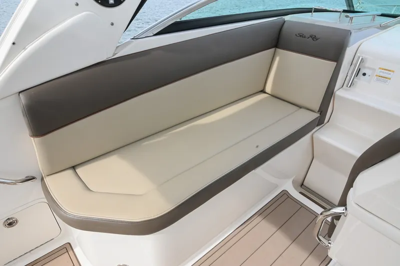 Slide: The Image of 2014 Sea Ray Sundancer 260 boat interior with beige seating and sleek design. - 28