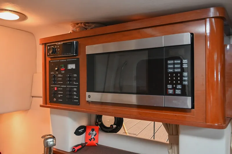 Slide: The Image of Interior of 2014 Sea Ray Sundancer 260 with microwave and control panel. - 43