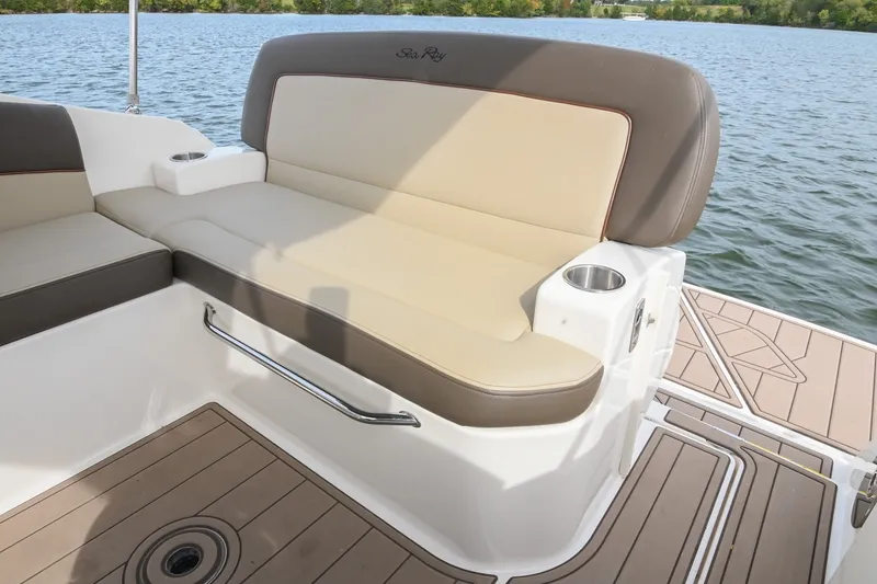 Slide: The Image of 2014 Sea Ray Sundancer 260 boat seating area with cup holders on a lake. - 24