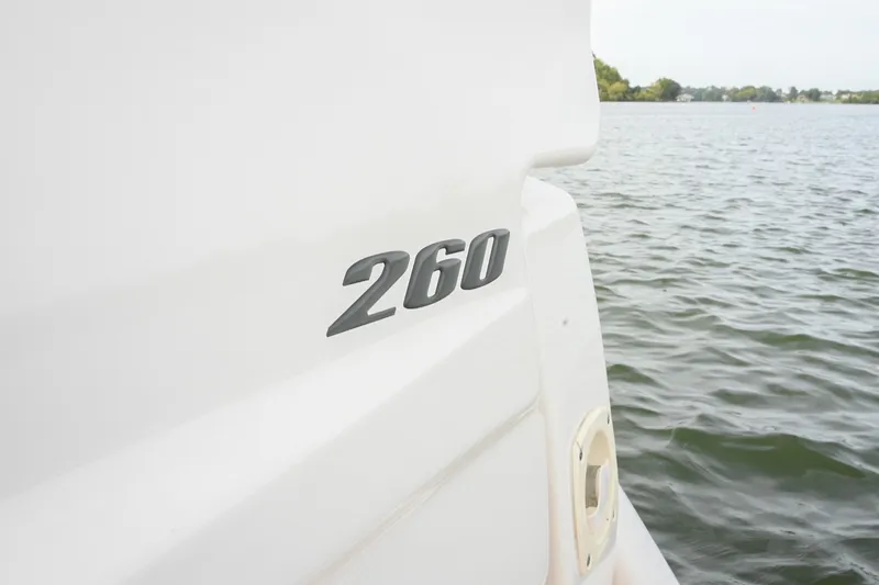 Slide: The Image of Close-up of 2014 Sea Ray Sundancer 260 boat on water, showcasing model number. - 20