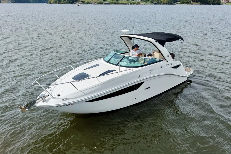 Slide: The Image of 2014 Sea Ray Sundancer 260 boat cruising on a calm lake. - 14