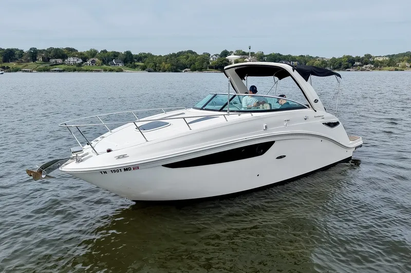 Slide: The Image of 2014 Sea Ray Sundancer 260 cruising on a calm lake with scenic shoreline. - 13