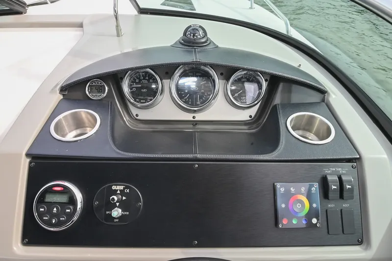 Slide: The Image of Dashboard of a 2014 Sea Ray Sundancer 260 boat with gauges and controls. - 32