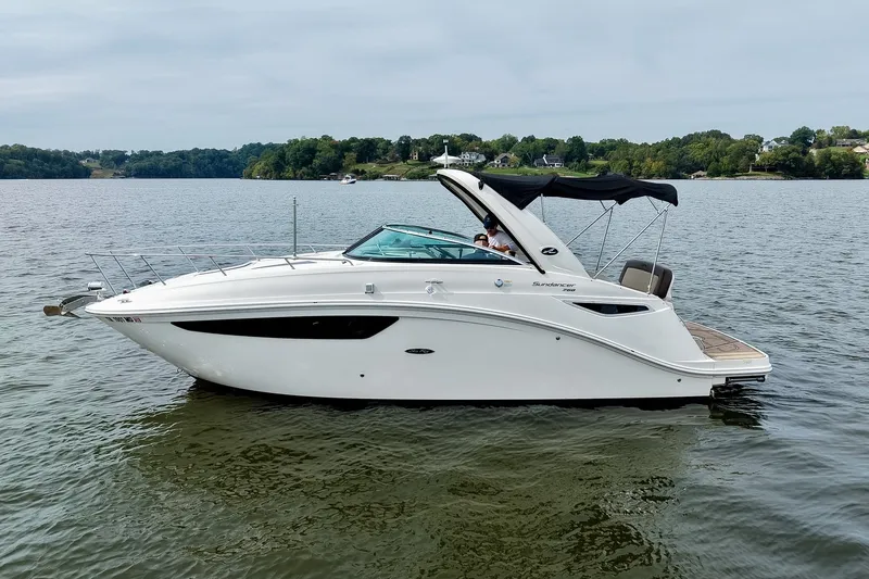 Slide: The Image of 2014 Sea Ray Sundancer 260 boat on calm lake with scenic background. - 15