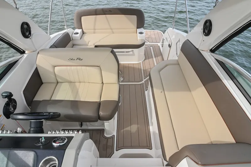 Slide: The Image of Interior of 2014 Sea Ray Sundancer 260 boat with beige seating and steering console. - 36