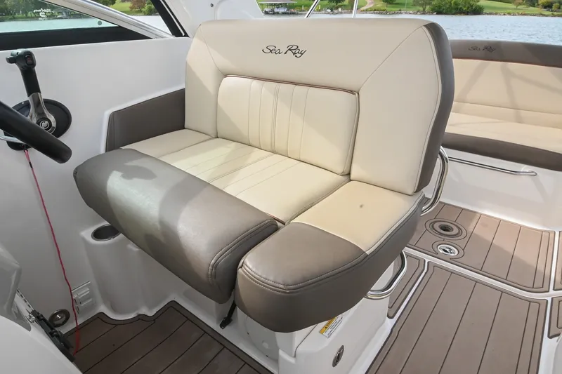 Slide: The Image of 2014 Sea Ray Sundancer 260 interior with beige and gray seating, showcasing luxury boat design. - 34