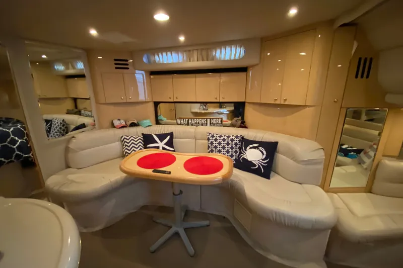 Slide: The Image of Interior of 1999 Sea Ray 380 Sundancer yacht with cozy seating and nautical decor. - 27