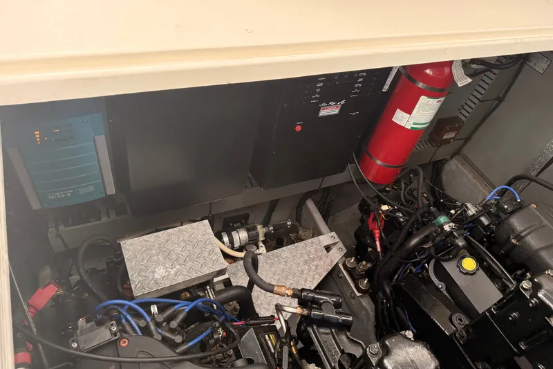 Slide: The Image of Engine compartment of a 1999 Sea Ray 380 Sundancer, featuring mechanical components and a fire extinguisher. - 41
