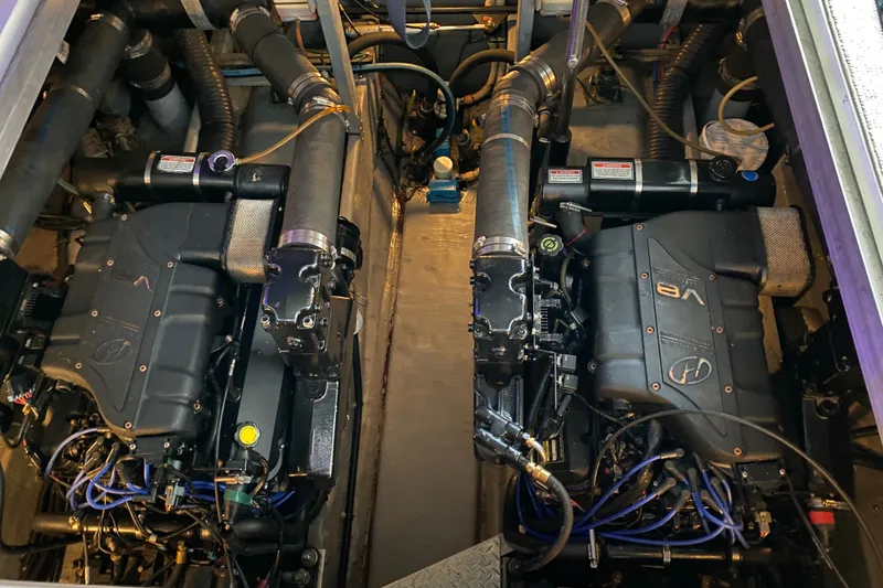 Slide: The Image of Engine compartment of a 1999 Sea Ray 380 Sundancer, showcasing dual inboard engines. - 31