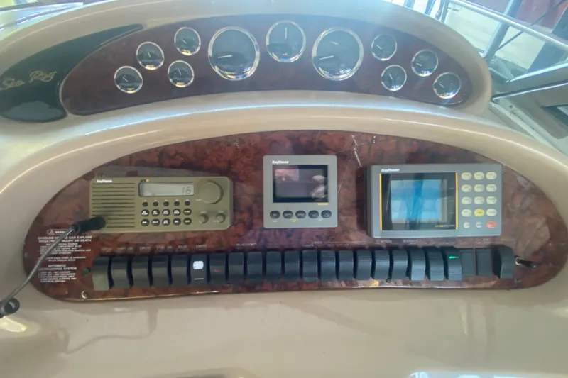 Slide: The Image of 1999 Sea Ray 380 Sundancer dashboard with gauges and navigation equipment. - 17