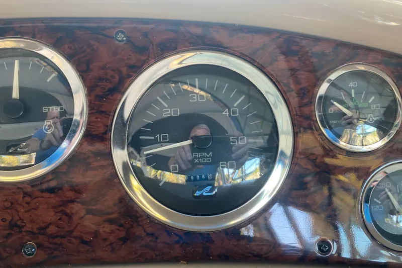 Slide: The Image of Dashboard of a 1999 Sea Ray 380 Sundancer boat with RPM and pressure gauges. - 25