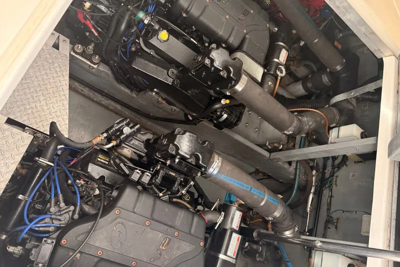 Slide: The Image of Engine compartment of a 1999 Sea Ray 380 Sundancer boat, showcasing dual engines. - 33
