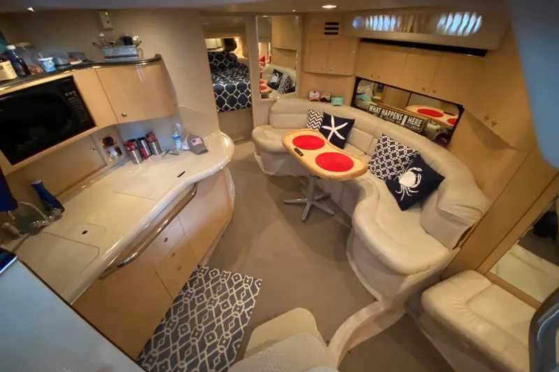 Slide: The Image of Luxurious interior of 1999 Sea Ray 380 Sundancer yacht with cozy seating and modern amenities. - 29