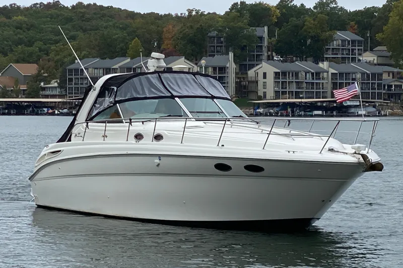 Slide: The Image of 1999 Sea Ray 380 Sundancer yacht on a lake with buildings in the background. - 5