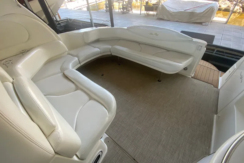 Slide: The Image of 1999 Sea Ray 380 Sundancer interior with white leather seating and carpeted flooring. - 21