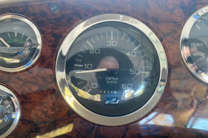 Slide: The Image of Dashboard gauges of a 1999 Sea Ray 380 Sundancer boat, showing RPM and other indicators. - 18