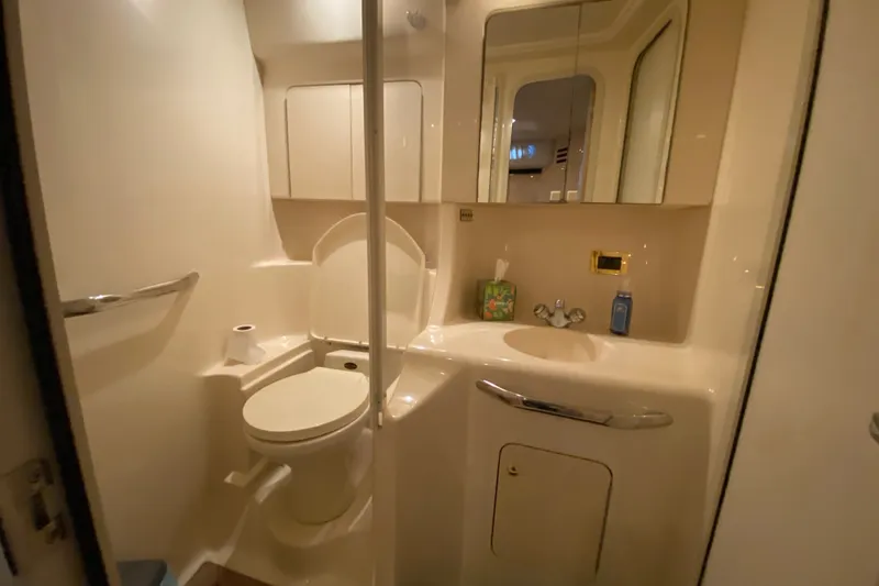 Slide: The Image of Bathroom interior of 1999 Sea Ray 380 Sundancer yacht, featuring toilet and sink. - 33