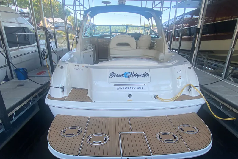 Slide: The Image of 1999 Sea Ray 380 Sundancer docked at Lake Ozark, MO, featuring spacious deck and seating. - 10