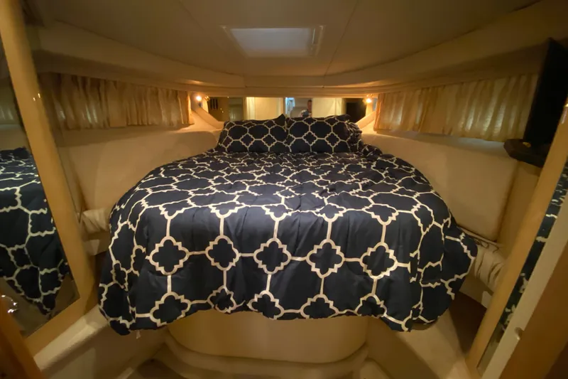 Slide: The Image of Luxurious cabin interior of 1999 Sea Ray 380 Sundancer with patterned bedding. - 26