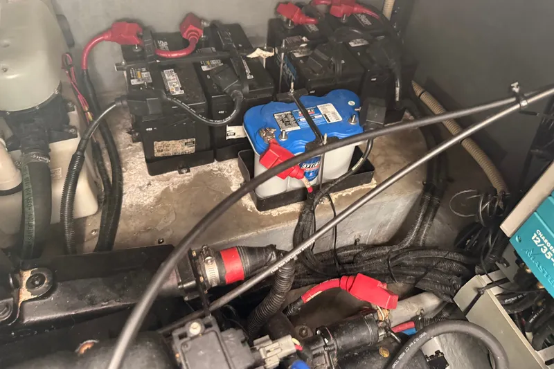 Slide: The Image of Engine compartment of a 1999 Sea Ray 380 Sundancer with visible batteries and wiring. - 37