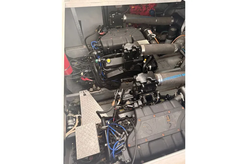 Slide: The Image of Engine compartment of a 1999 Sea Ray 380 Sundancer boat, showcasing mechanical components. - 39
