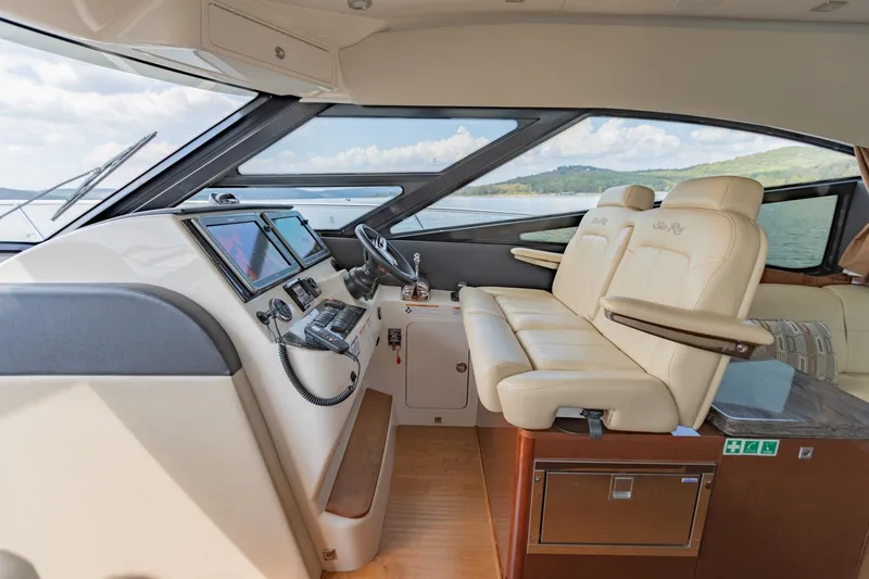 Slide: The Image of Luxurious interior of 2015 Sea Ray 470 Sundancer yacht with leather seating and modern controls. - 14