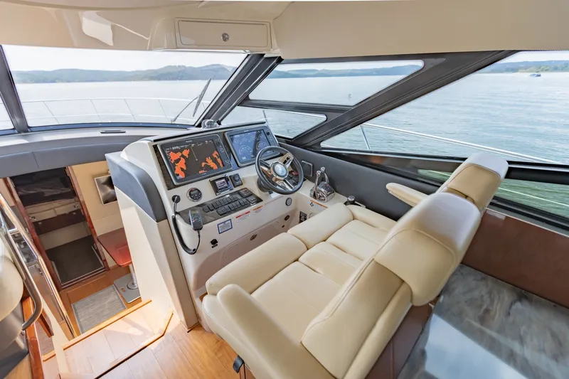 Slide: The Image of 2015 Sea Ray 470 Sundancer helm with modern navigation system and luxurious seating. - 15