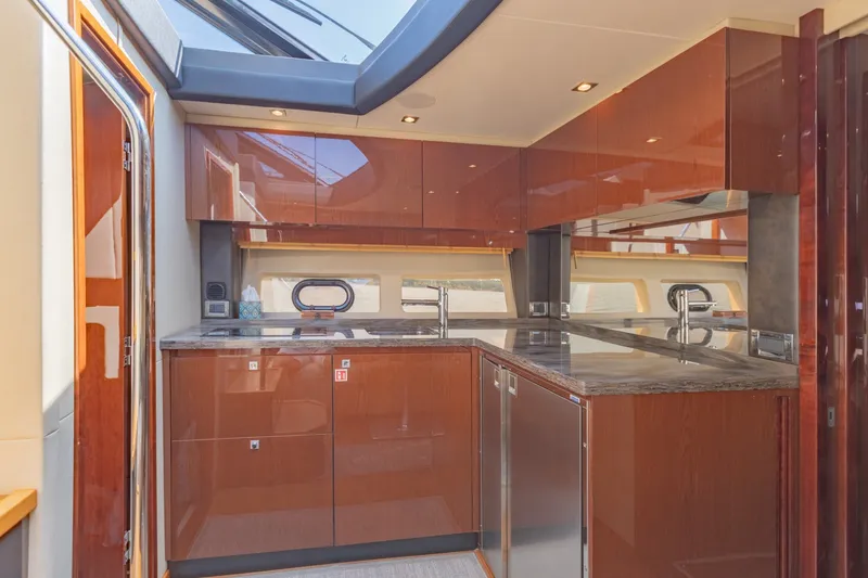 Slide: The Image of Luxurious kitchen interior of 2015 Sea Ray 470 Sundancer yacht with modern cabinetry. - 19