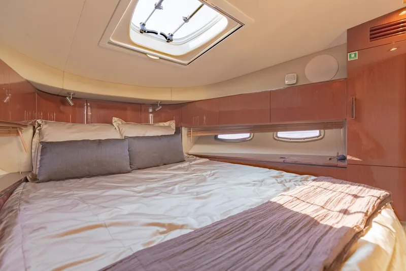 Slide: The Image of Luxurious bedroom interior of 2015 Sea Ray 470 Sundancer yacht with skylight and elegant bedding. - 25
