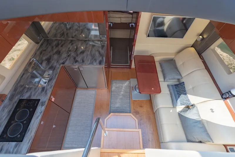 Slide: The Image of Luxurious interior of 2015 Sea Ray 470 Sundancer yacht with modern kitchen and cozy seating area. - 17