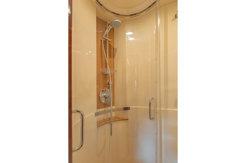 Slide: The Image of Shower area inside 2015 Sea Ray 470 Sundancer yacht, featuring glass doors and modern fixtures. - 30