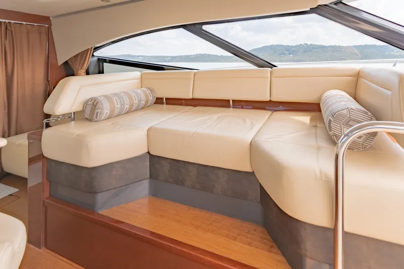 Slide: The Image of Luxurious interior seating of 2015 Sea Ray 470 Sundancer yacht with scenic window view. - 13