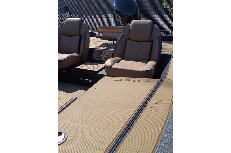 Slide: The Image of 2026 EXPRESS BOAT EXPRESS H18C interior with tan seats and deck. - 5
