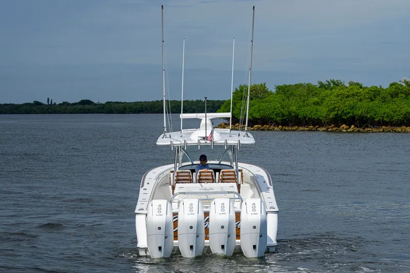 Slide: The Image of 2026 Valhalla V-41 boat with four engines cruising on a calm waterway. - 10