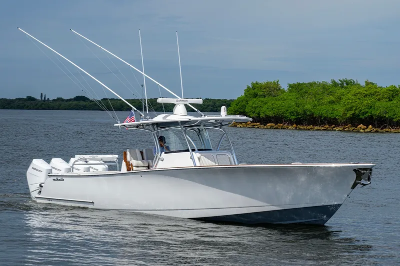 Slide: The Image of Valhalla V-41 2026 boat cruising on a calm river with lush green shoreline. - 5
