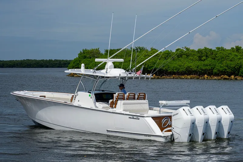 Slide: The Image of 2026 Valhalla V-41 boat with four engines cruising on a calm waterway. - 9
